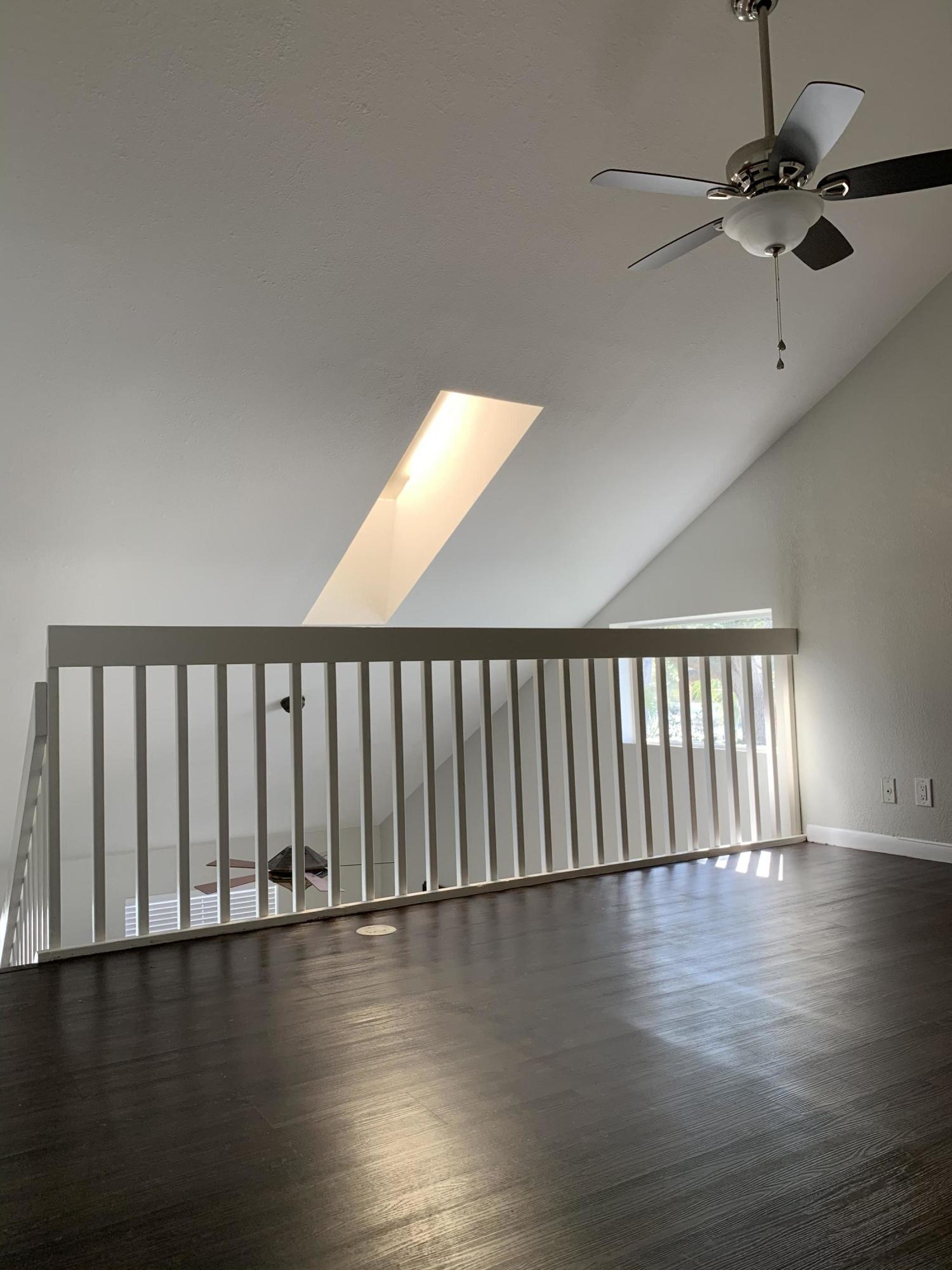 320 Southeast 2nd Avenue, Unit B1 Deerfield Beach, FL 33441 - Photo 19 of 22 a view of a room with wooden floor fan and windows