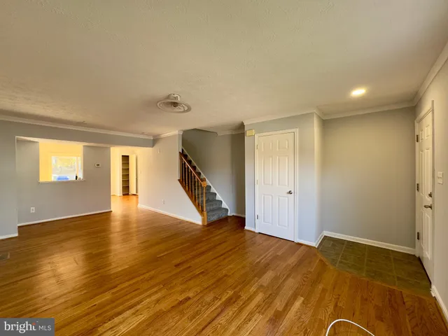 a view of an empty room and wooden floor