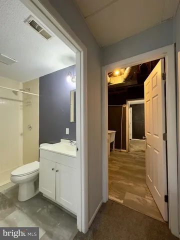 a bathroom with a toilet sink and a mirror