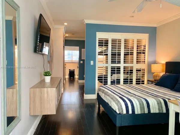 a bedroom with bed and wooden floor