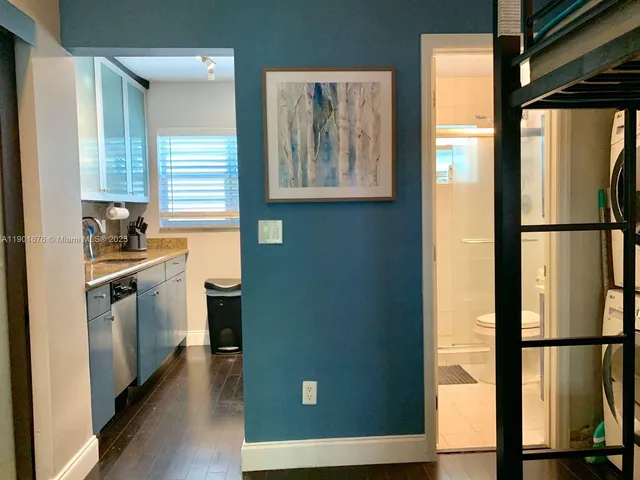 a kitchen with stainless steel appliances granite countertop a refrigerator and a window