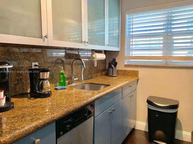 a kitchen with a sink and a window