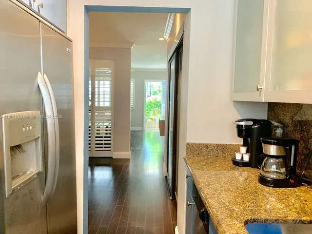 a kitchen with a refrigerator and a stove