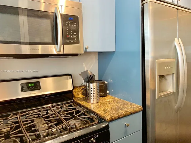 a kitchen with a stove and a refrigerator