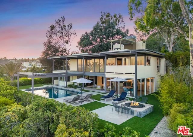 a view of backyard with swimming pool and patio