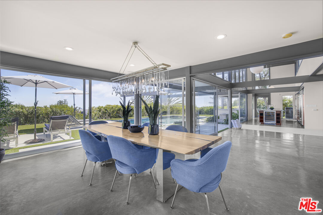 9892 Beverly Grove Drive Beverly Hills, CA 90210 - Photo 17 of 39 a view of a dining room with furniture wooden floor and chandelier