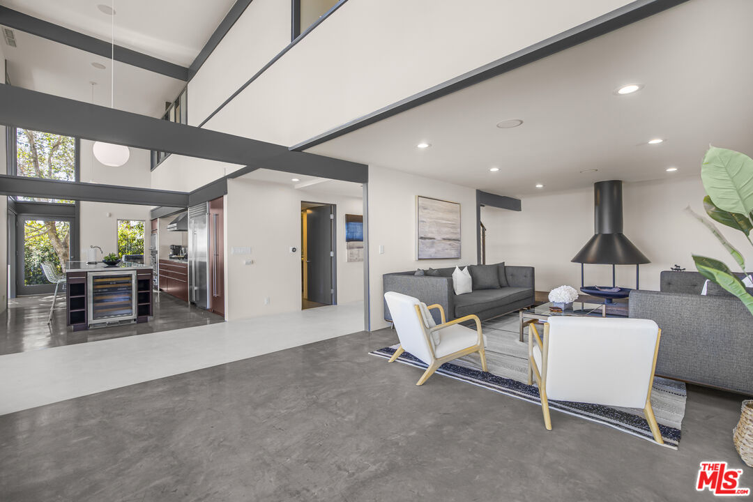 9892 Beverly Grove Drive Beverly Hills, CA 90210 - Photo 22 of 39 a living room with furniture a ceiling fan and a large window