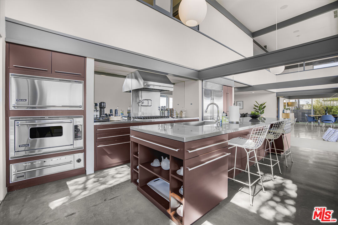 9892 Beverly Grove Drive Beverly Hills, CA 90210 - Photo 24 of 39 a kitchen with stainless steel appliances granite countertop a stove and a refrigerator