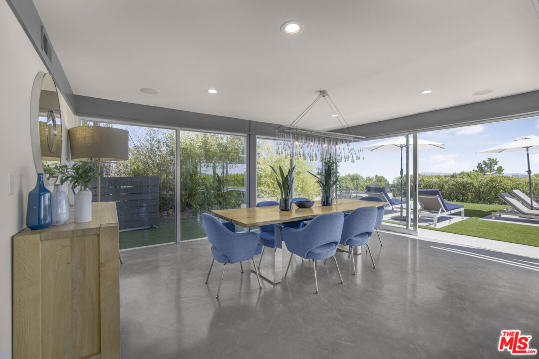 9892 Beverly Grove Drive Beverly Hills, CA 90210 - Photo 27 of 39 a dining room with furniture and a floor to ceiling window