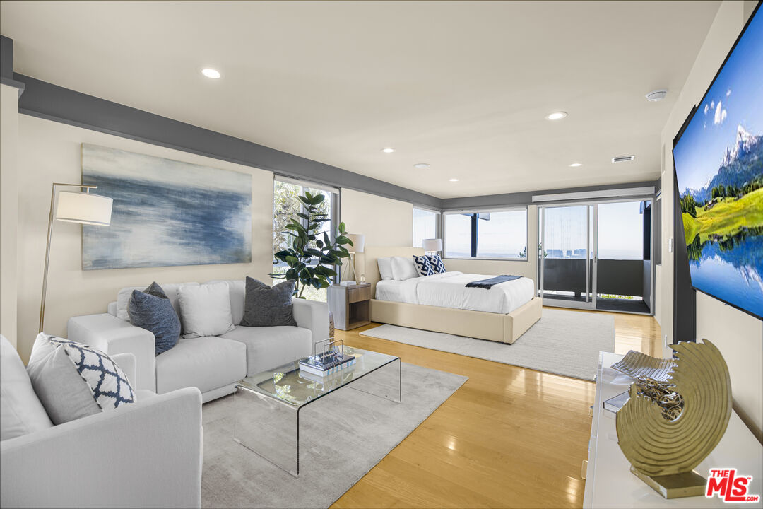 9892 Beverly Grove Drive Beverly Hills, CA 90210 - Photo 28 of 39 a living room with furniture and a potted plant