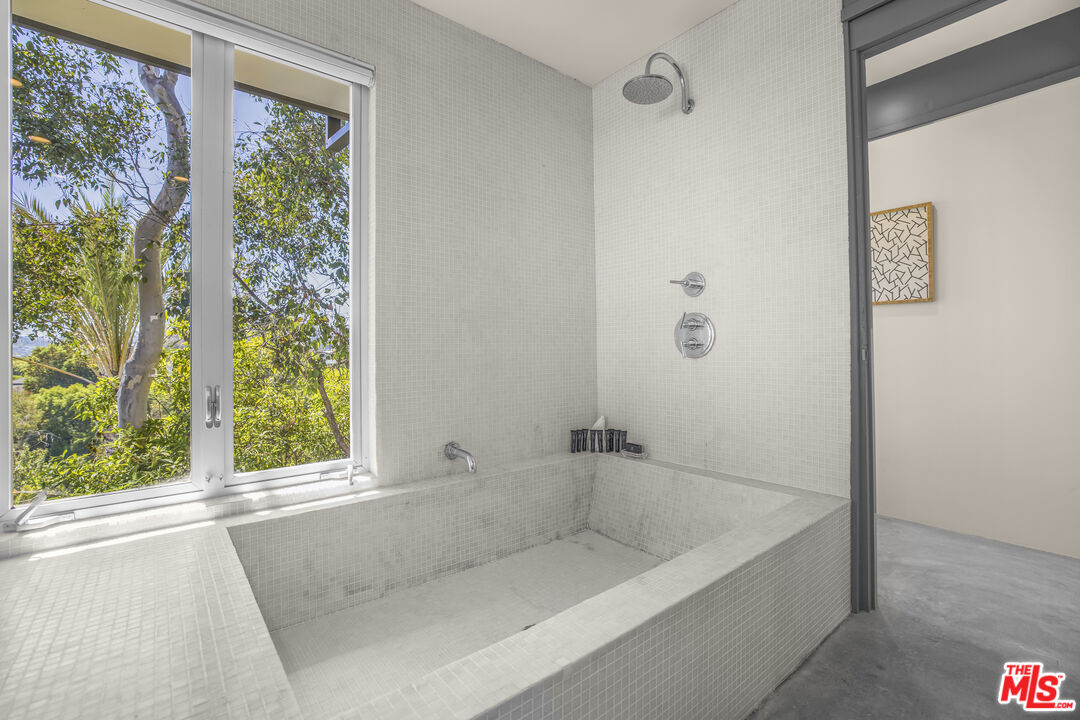 9892 Beverly Grove Drive Beverly Hills, CA 90210 - Photo 29 of 39 a bathroom with a bathtub and window