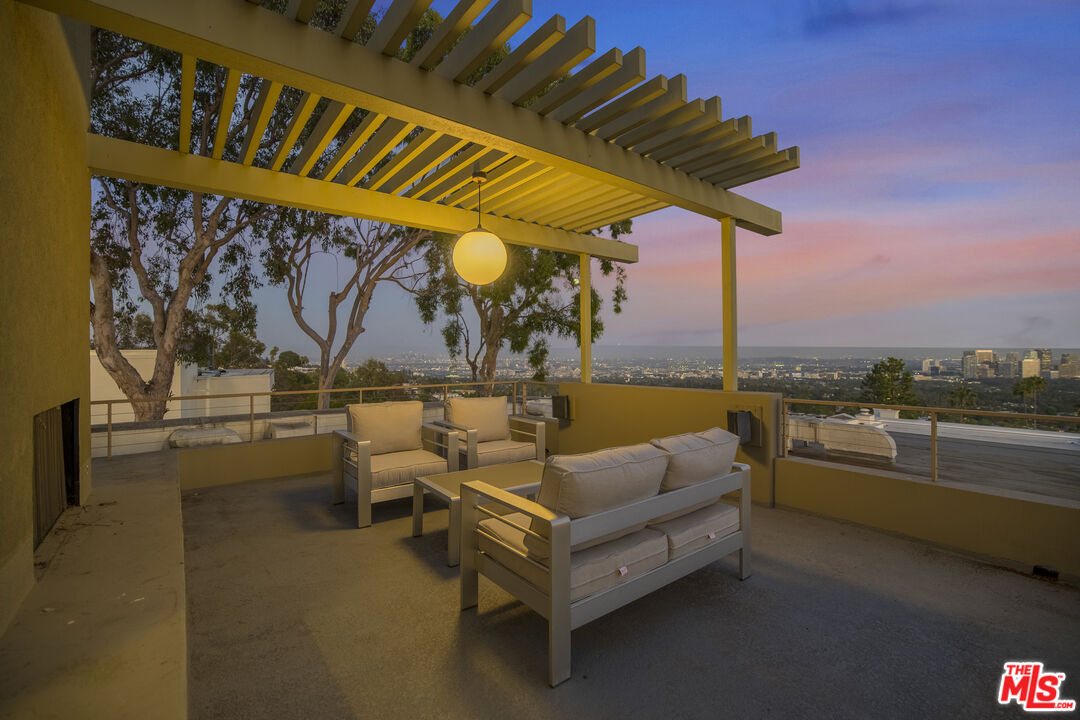 9892 Beverly Grove Drive Beverly Hills, CA 90210 - Photo 32 of 39 a roof deck with couches and potted plants