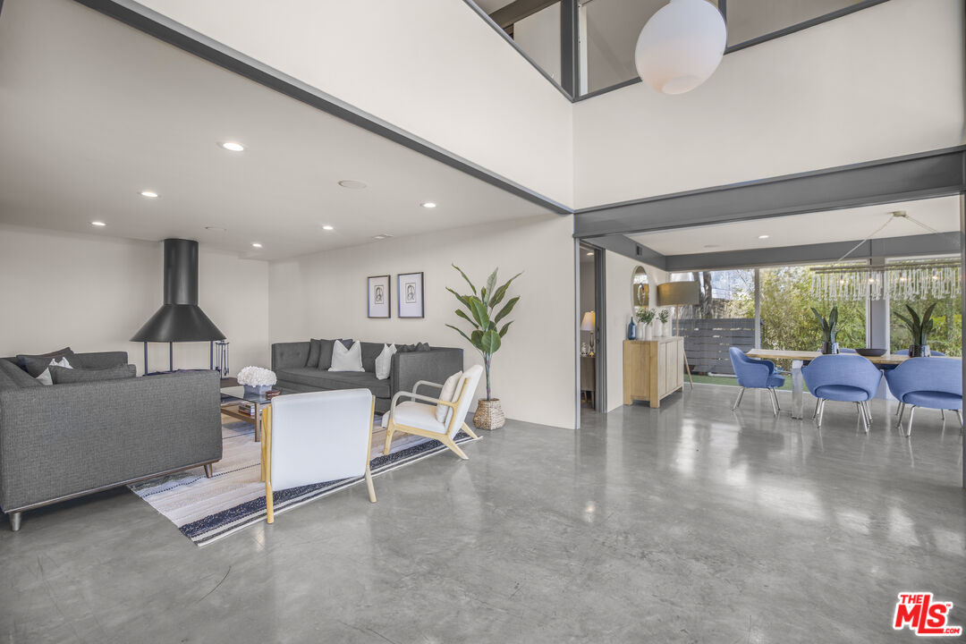 9892 Beverly Grove Drive Beverly Hills, CA 90210 - Photo 34 of 39 a living room with furniture a wooden floor and a large window