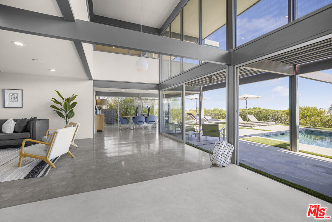 9892 Beverly Grove Drive Beverly Hills, CA 90210 - Photo 35 of 39 a dining room with wooden floor and glass door