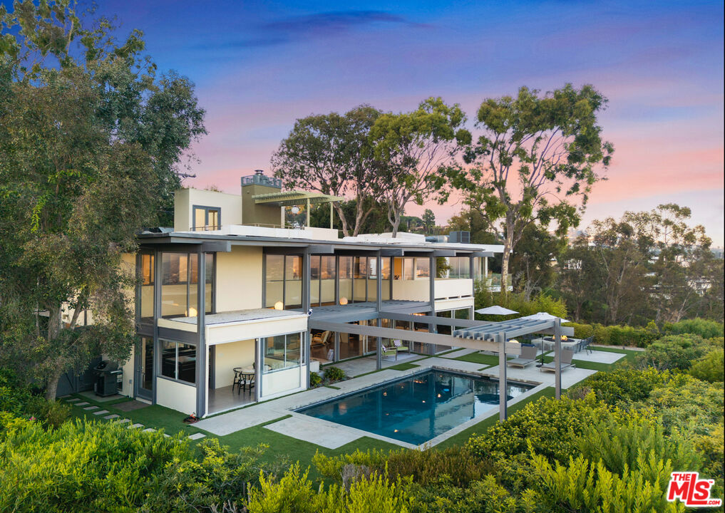 9892 Beverly Grove Drive Beverly Hills, CA 90210 - Photo 39 of 39 a view of a house with pool and chairs