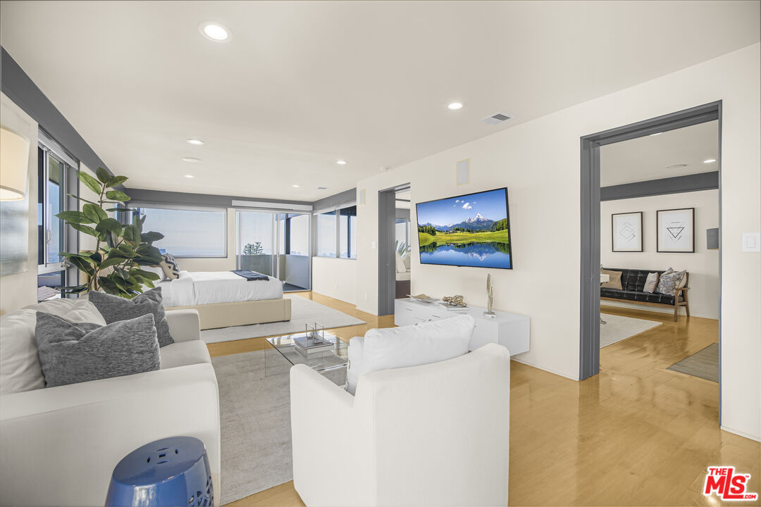 9892 Beverly Grove Drive Beverly Hills, CA 90210 - Photo 6 of 39 a living room with furniture and a flat screen tv