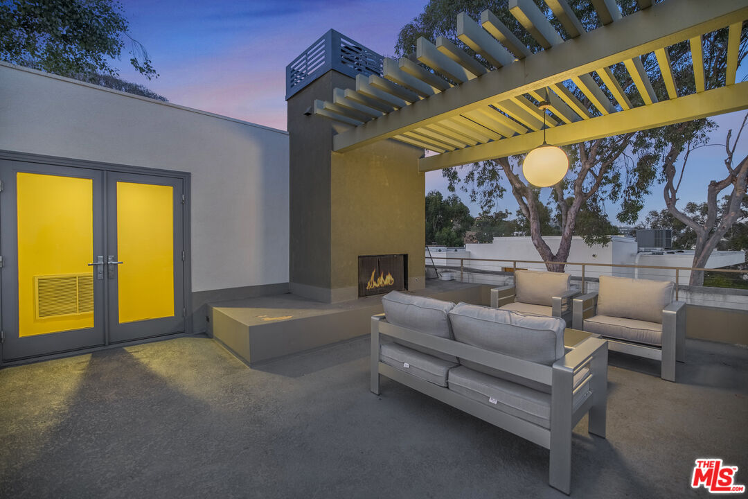 9892 Beverly Grove Drive Beverly Hills, CA 90210 - Photo 7 of 39 a living room with furniture and a large window