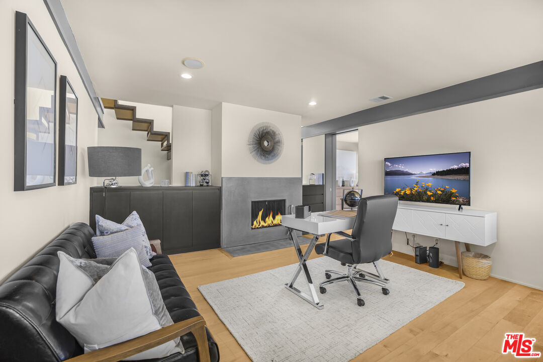 9892 Beverly Grove Drive Beverly Hills, CA 90210 - Photo 8 of 39 a living room with furniture and a flat screen tv