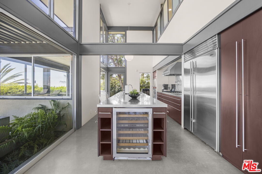 9892 Beverly Grove Drive Beverly Hills, CA 90210 - Photo 10 of 39 a kitchen with furniture a counter top space and stainless steel appliances