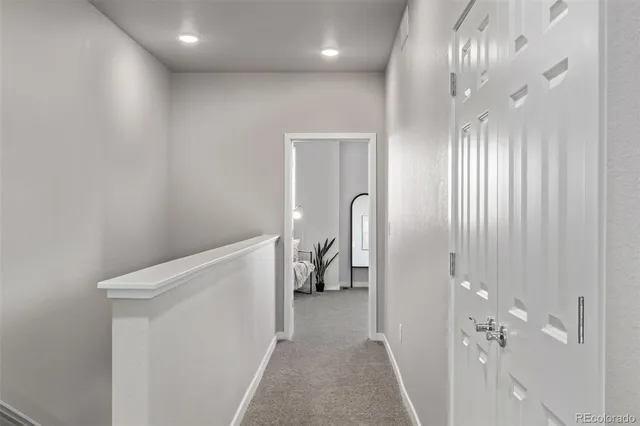 a view of a hallway with paintings on the wall