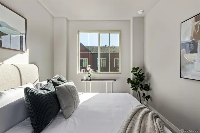 a bedroom with a bed and windows