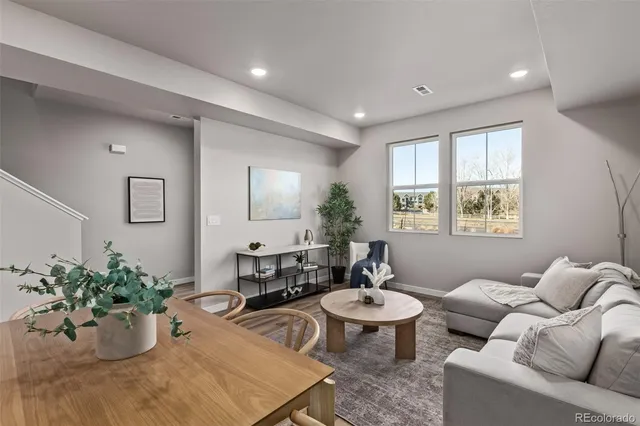 a living room with furniture potted plant and a window