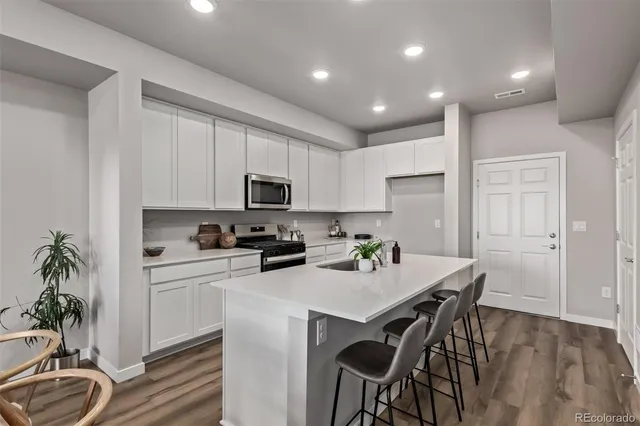 a kitchen with a table a sink and cabinets