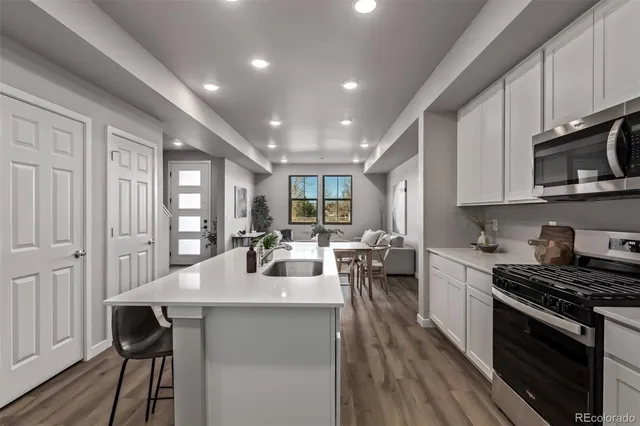 a kitchen with sink a stove and cabinets