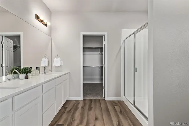a bathroom with a double vanity sink and mirror