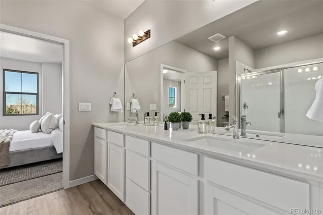 a en suite bathroom with double sink and a large mirror