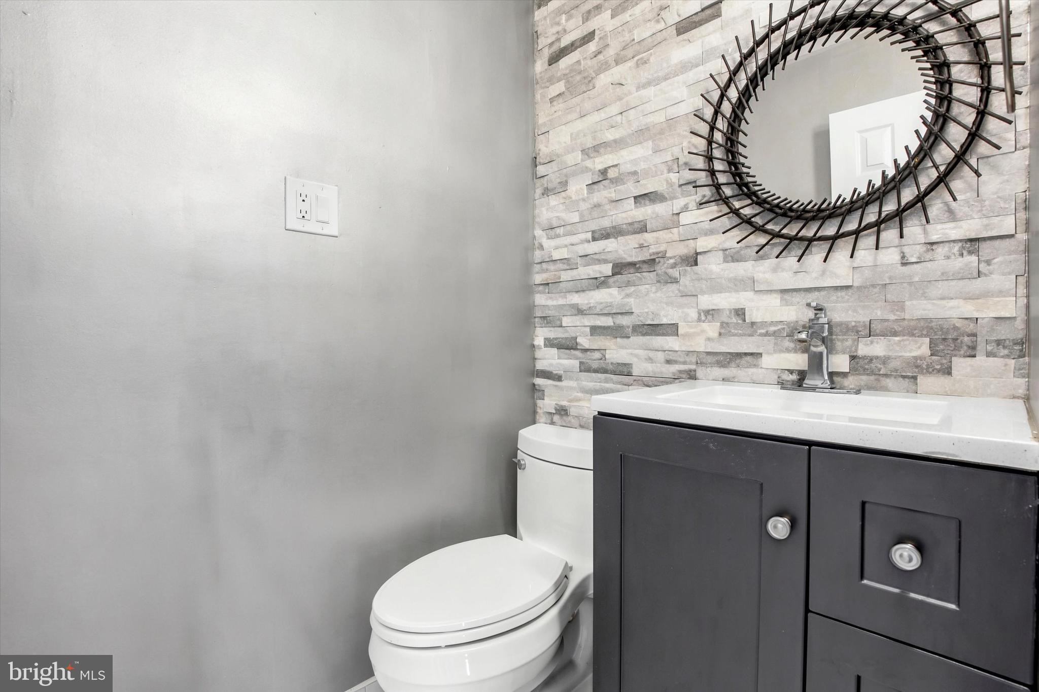1167 Cushmore Road Southampton, PA 18966 - Photo 14 of 25 a bathroom with a sink mirror a toilet and a mirror