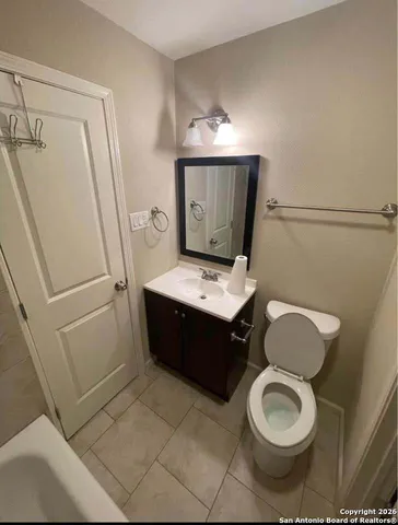 a bathroom with a sink a toilet and mirror