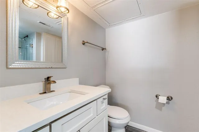 a bathroom with a sink toilet a mirror and vanity