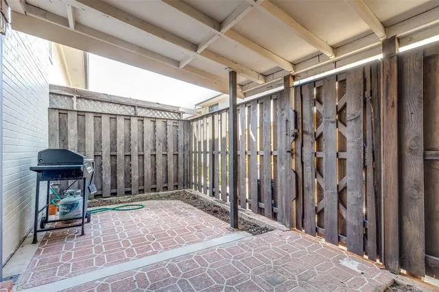 a view of a porch with a table and chairs
