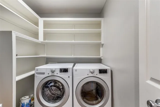 a view of storage and utility room with washer and dryer