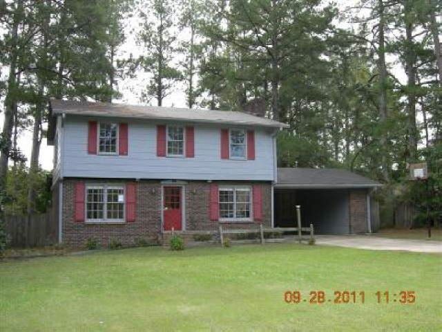 223 Burnett Ferry Road Southwest Rome, GA 30165 - Photo 1 of 1 a front view of a house with a garden