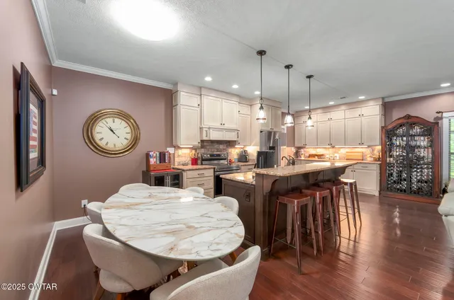 a utility room with a sink and wooden floor