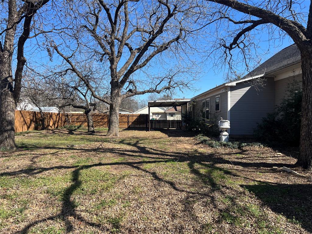 316 East Spring Street Henrietta, TX 76365 - Photo 9 of 28 a view of street with large trees