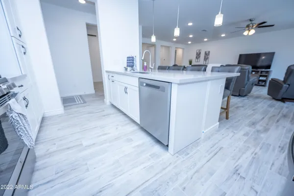 a kitchen with stainless steel appliances granite countertop a sink stove and wooden floor