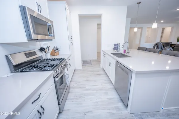 a kitchen with sink stove and cabinets