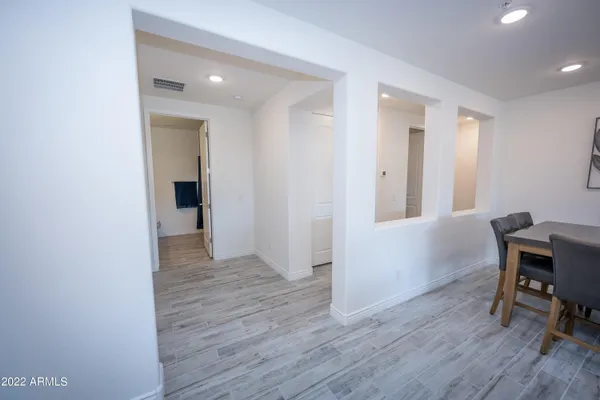 a workspace with wooden floor and furniture