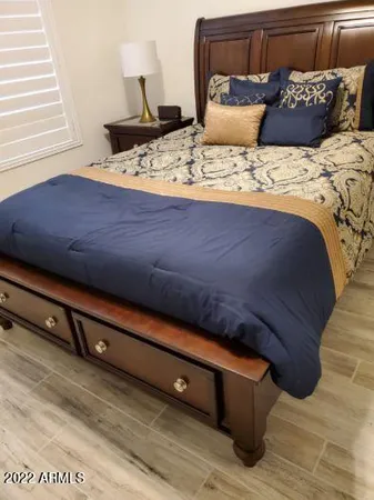 a bedroom with a bed and a window