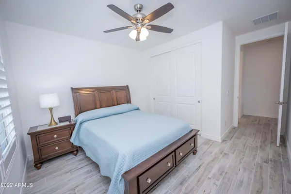 a bedroom with a bed and a ceiling fan