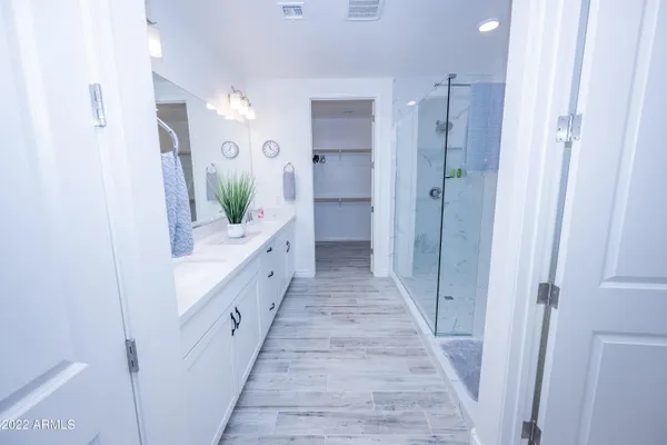 a bathroom with a double vanity sink and a mirror