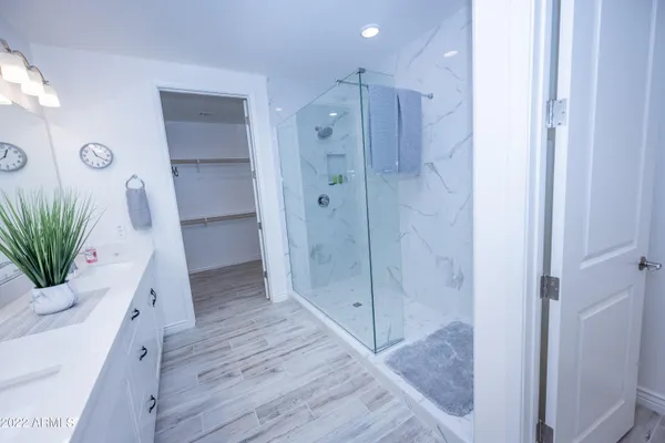 a bathroom with a shower and a mirror