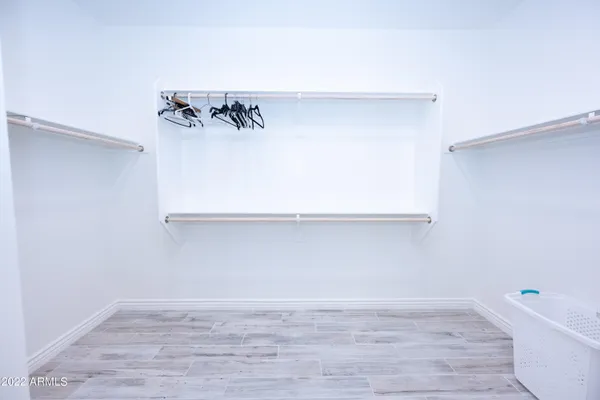 a view of a closet with wooden floor