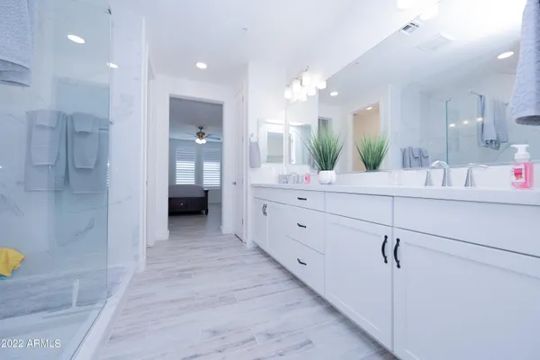 a bathroom with a double vanity sink and a mirror