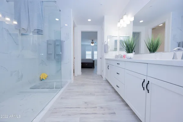 a bathroom with a tub sink and mirror