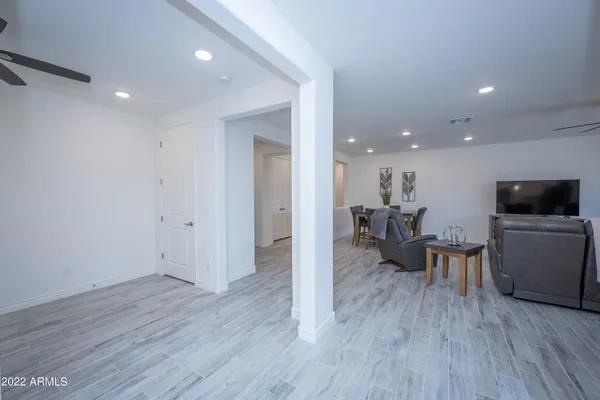 a view of a living room and dining room with furniture and wooden floor