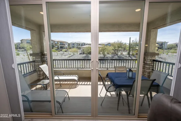 a view of a chairs and table in balcony